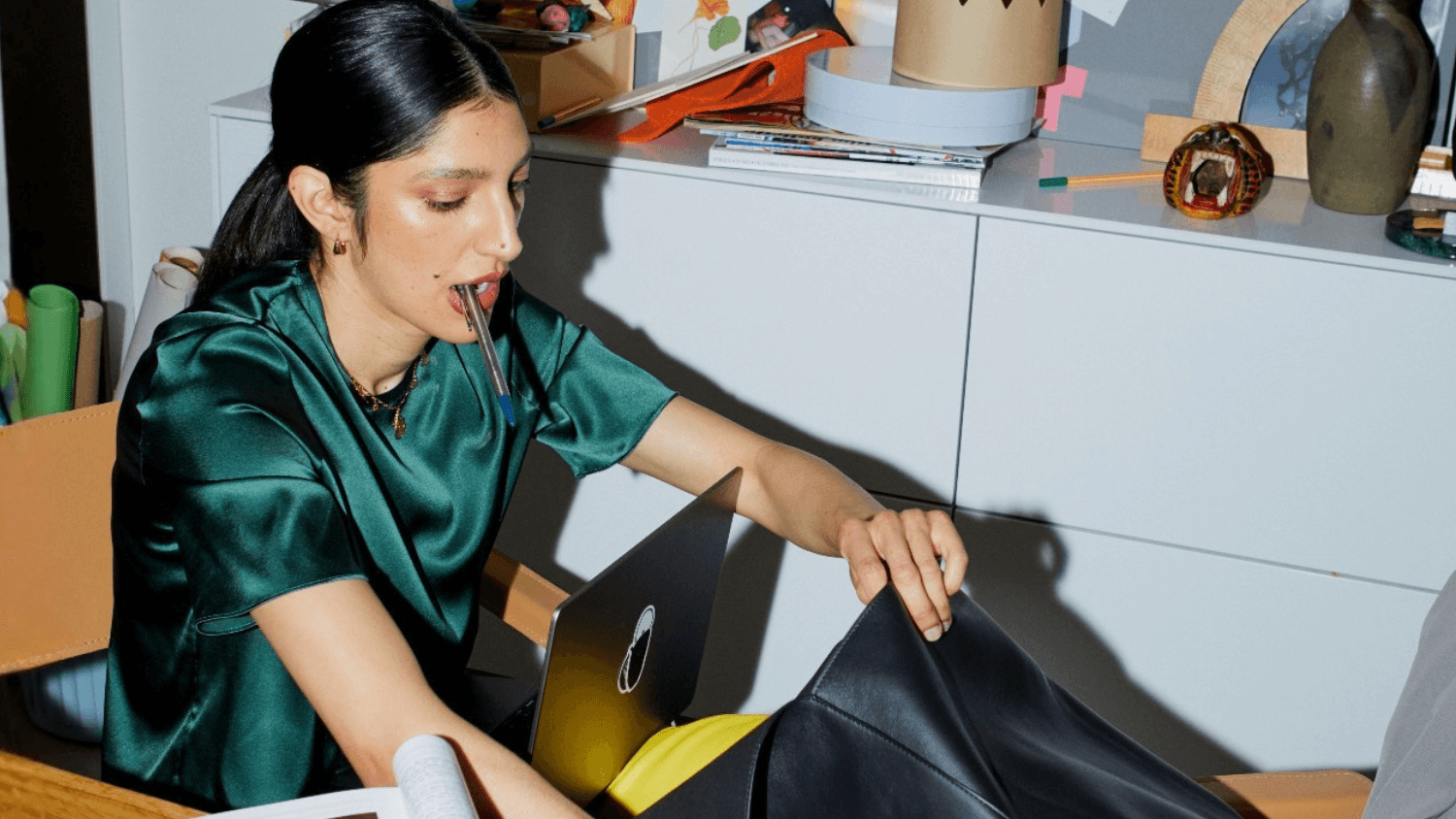 An immigrant who just moved to Canada rummaging through their bag while reading a newcomer financial guide