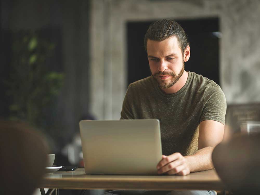 A Canadian man looking at his options online for building an emergency fund: a line of credit vs savings account.