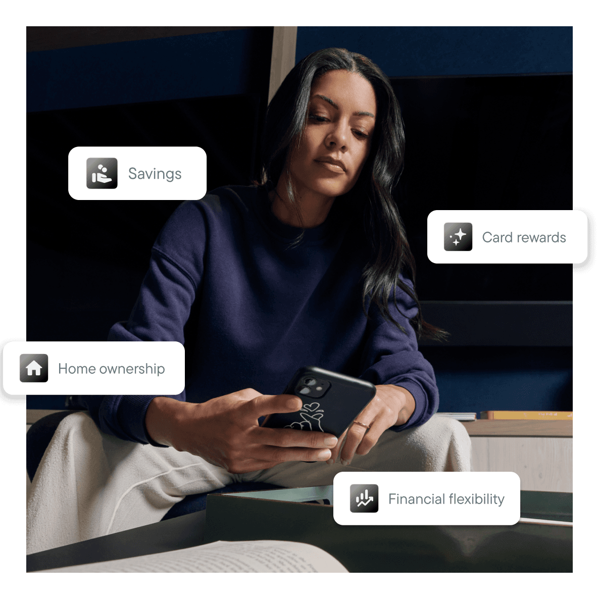 Woman sitting and looking at a phone, with labels for Savings, Card rewards, Home ownership, and Financial flexibility around her.