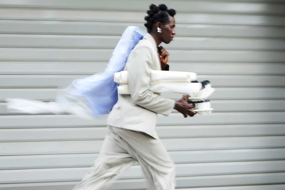 A young Canadian man, clearly working an entry level job, wondering if AI can take over his tasks, as he runs to the office.