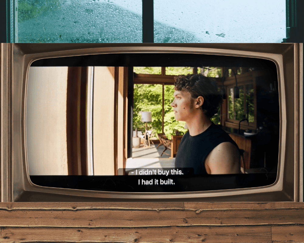 A scene from Heated Rivalry, with the character Ilya Rozanov on a cottage TV, saying, "I didn't buy this, I had it built."