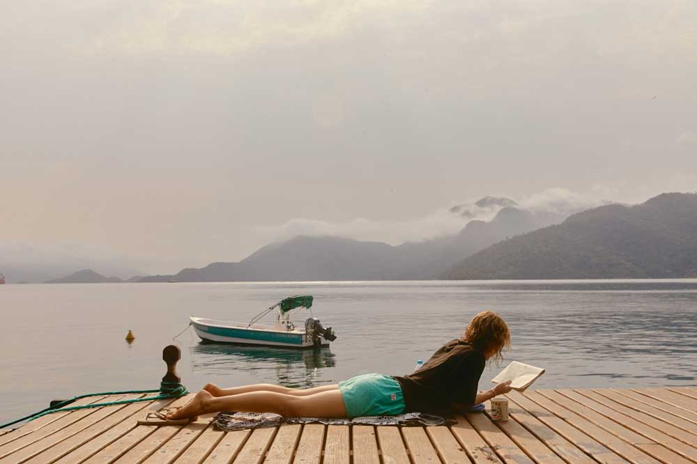 A single person on vacation in Canada's cottage country, enjoying the cost of their vacation by themselves.