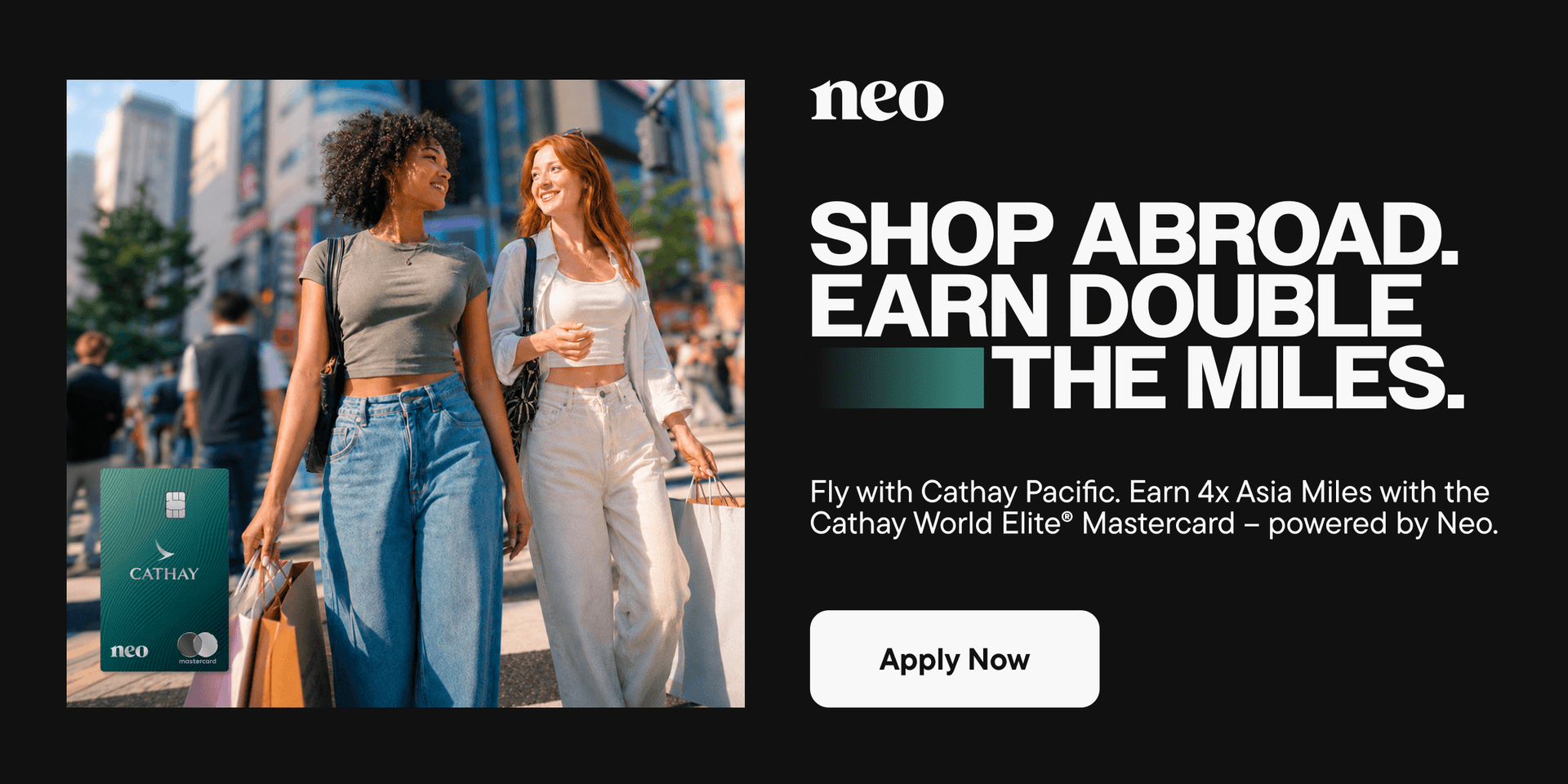 Two Canadians shopping in a foreign country using the Cathay World Elite® Mastercard – powered by Neo, to earn 4x Asia Miles on Cathay Pacific flights