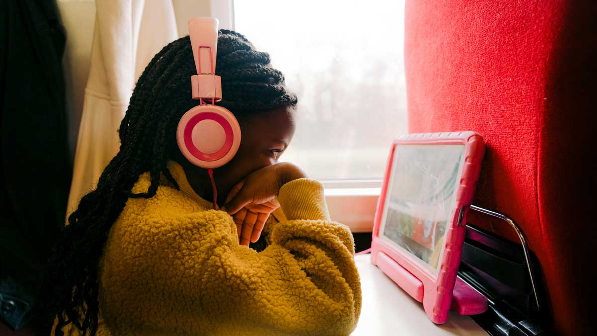 A Canadian girl on a train, watching a video, as she goes on an outing for March Break with her family. The last-minute staycation is meant to help save money for the family.