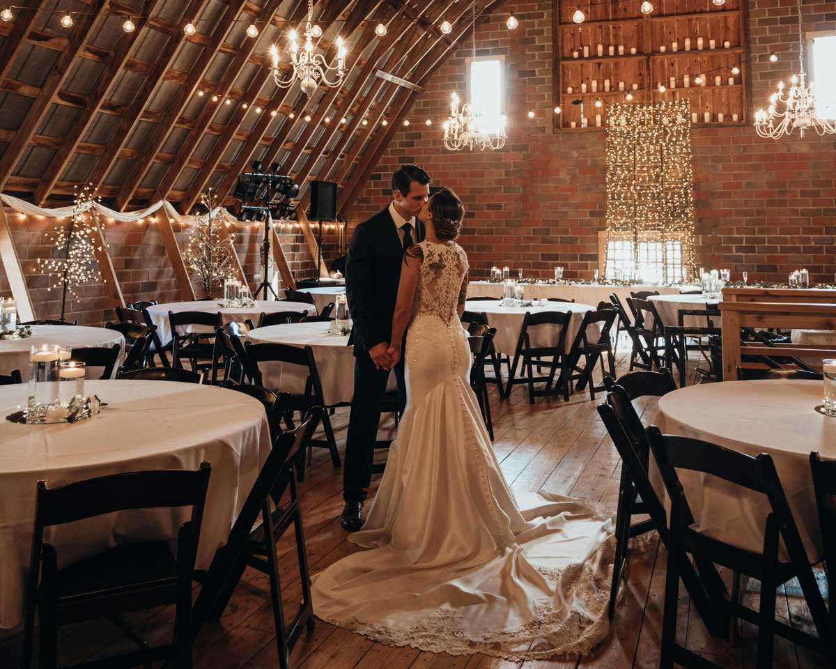 A Canadian couple in an empty hall, giving symbolism to the cost of weddings in Canada today.