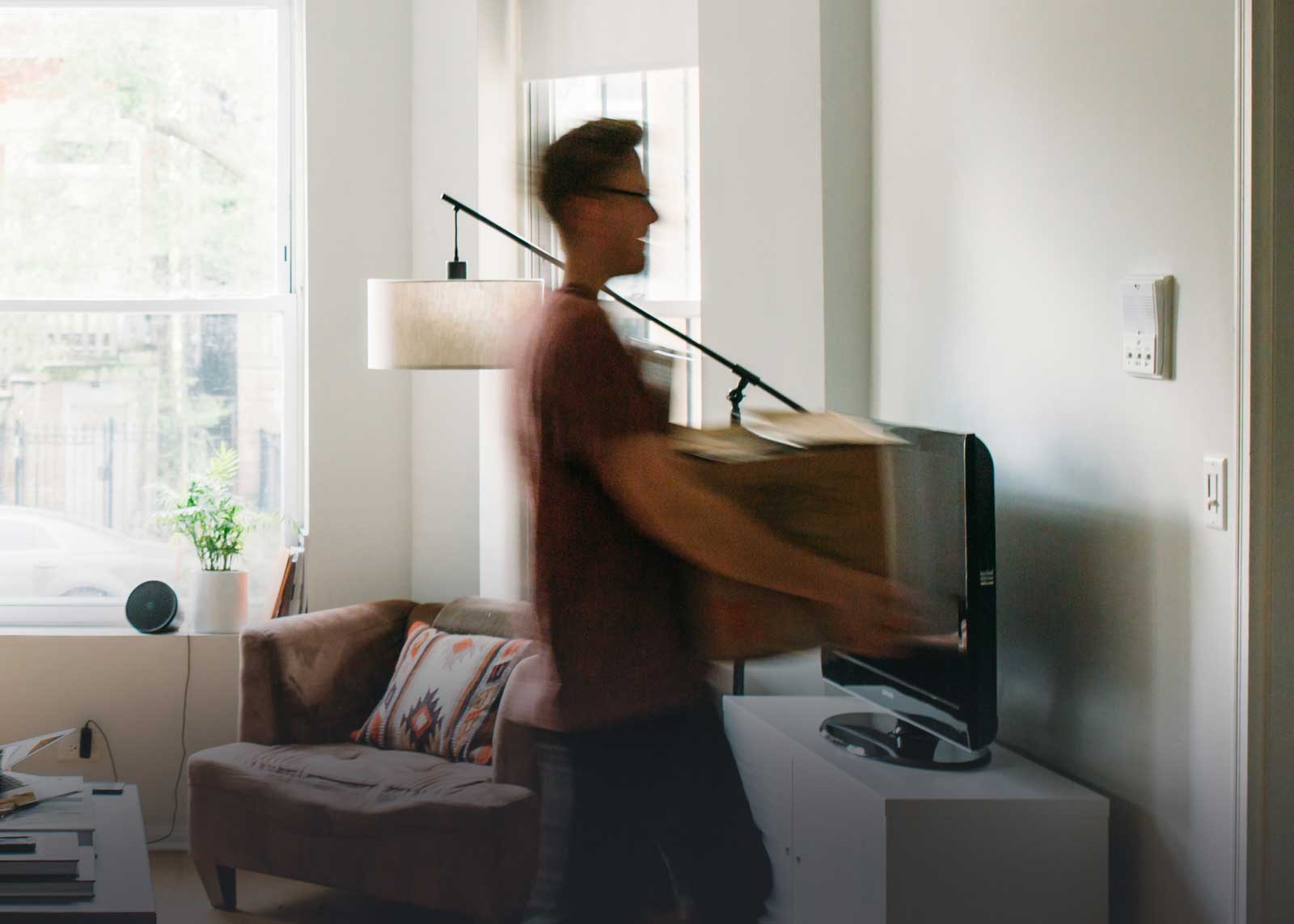 A Canadian young man, blurred, to symbolize that he's moving back in as fast as he moved out, making him a boomerang kid.
