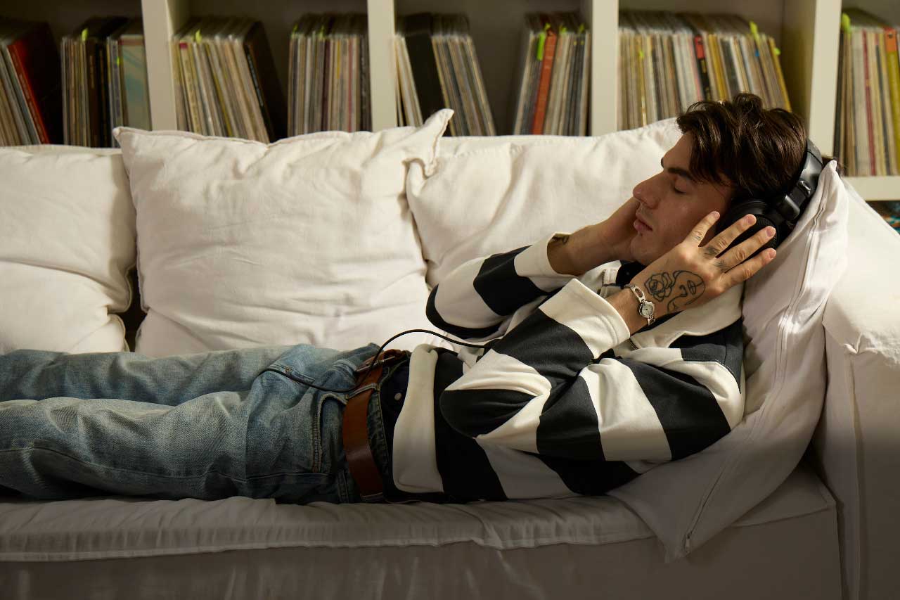 A Canadian man comfy at home, with his HVAC system running smoothly. He's wondering if the maintenance plan is worth it.