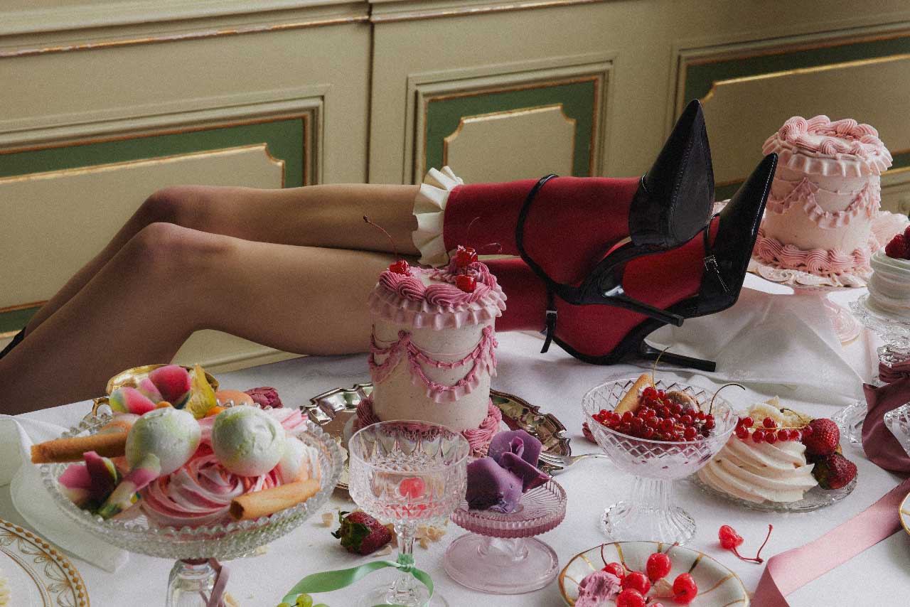 A table strewn with insta-worthy cakes and treats, and a Canadian with their feet on the table, symbolizing they're over it.