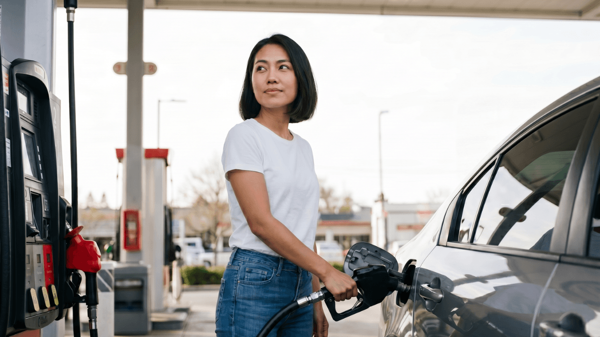 A person fuels up their car at a gas station, a transaction that can unlock cashback if paid for with the best gas credit card in Canada