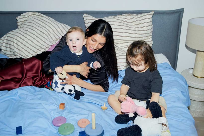 A Canadian mom playing with her kids, showing that she's a good source of money advice for her kids.