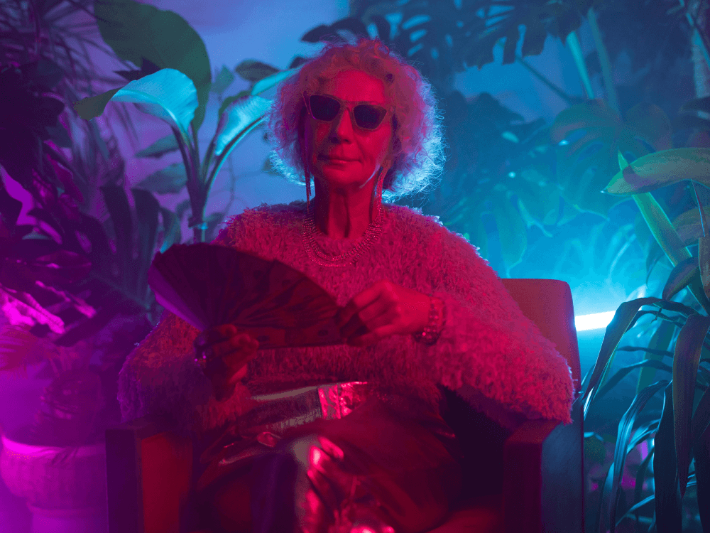 Making fun of the myth that you need a lot of money to start saving, a Canadian senior fans out a wad of cash at a club.