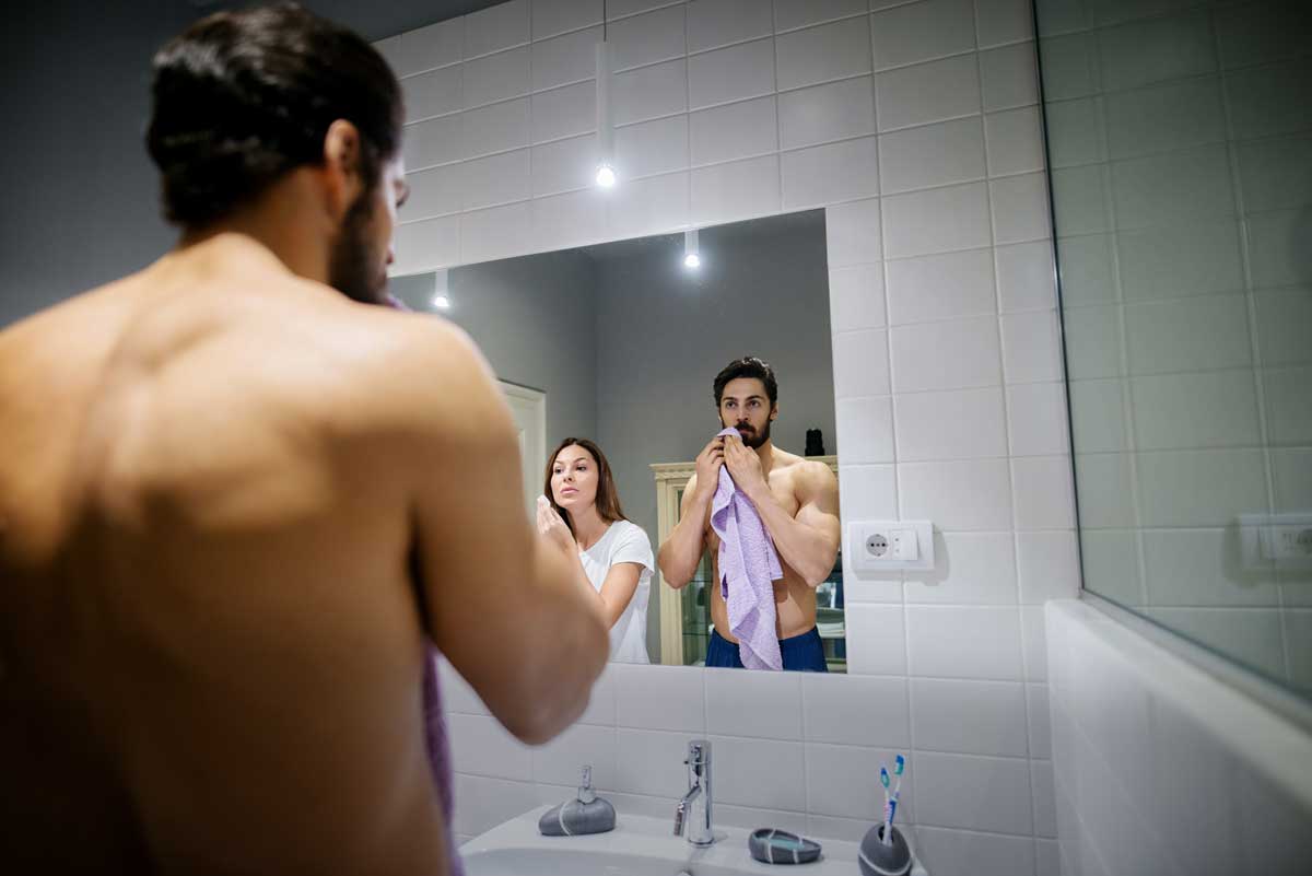 A Canadian man and a Canadian woman, together in a bathroom, comparing the costs of their cheap and expensive skincare creams, lotions, serums and more, and of course which ones actually work.