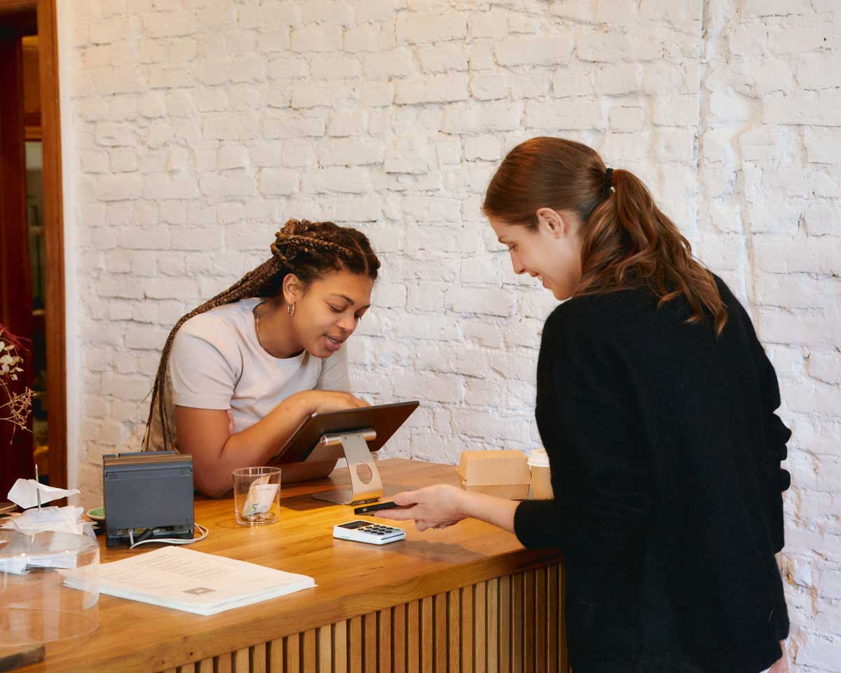 A Canadian woman tipping in front of her server. But does the server know how much they've been tipped?