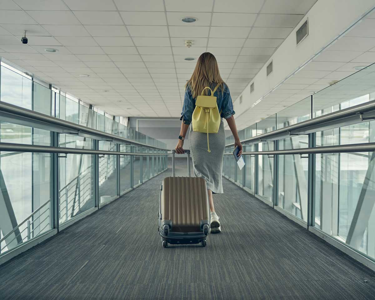 A Canadian traveller, boarding a plane, knowing that she has paid a fuel surcharge because of the price increases in jet fuel.
