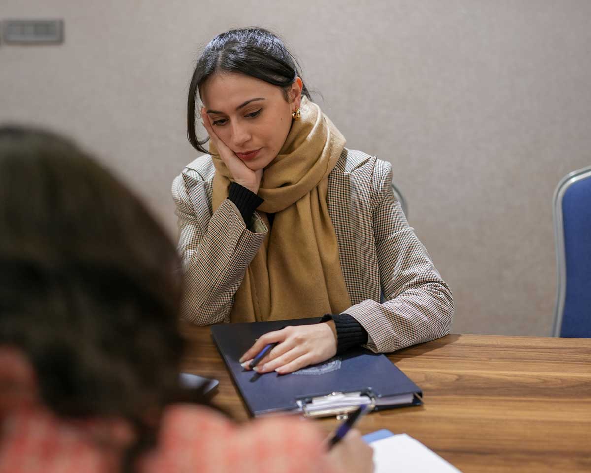 A Canadian woman grieving a loved one's passing, is meeting with a planner to discuss her finances.