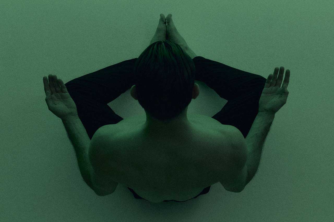 A Canadian man doing yoga, remaining calm, as the markets go wild and volatile.