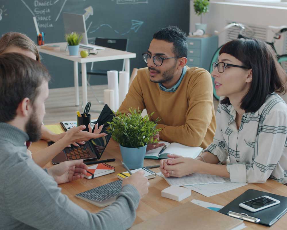 A group of friends and colleagues chatting about the Canadian economy.
