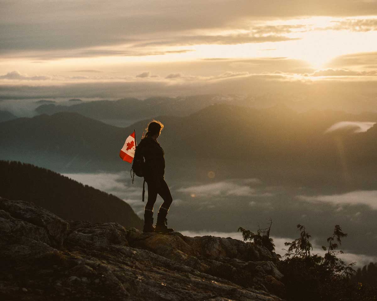 A traveller viewing a mountain sunset on a trip he used the Canada Strong Pass.