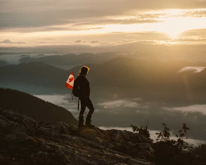 A traveller viewing a mountain sunset on a trip he used the Canada Strong Pass.
