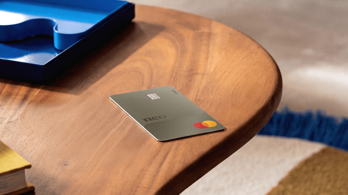 The Neo Mastercard, one of the Neo credit cards that will help build credit up in Canada, resting on a wooden surface
