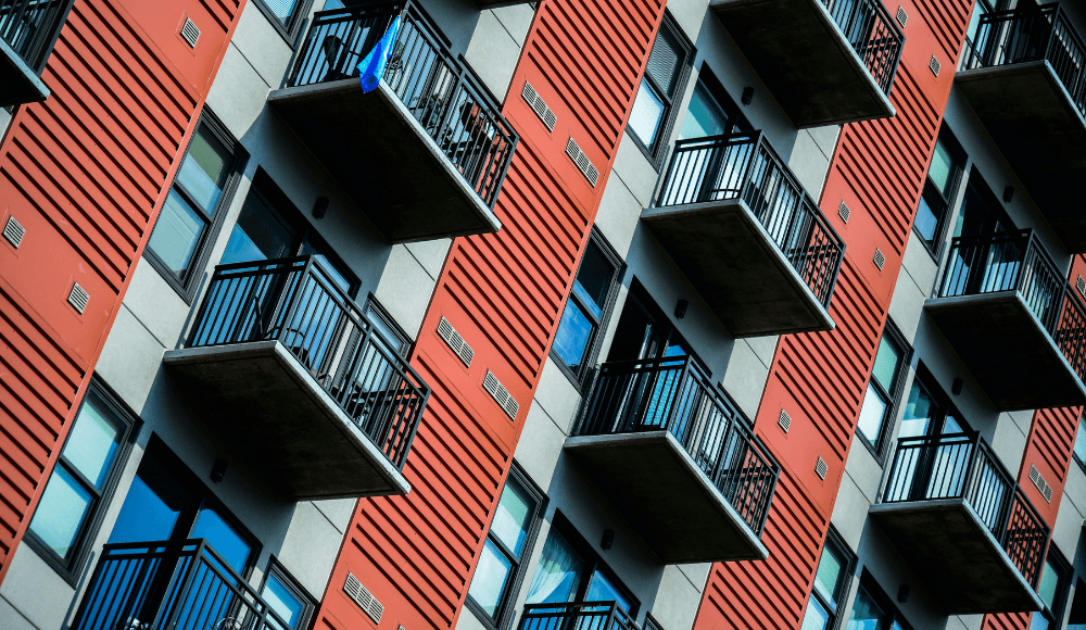An apartment building containing many tenants, that could decide to use rent reporting to boost their credit score.