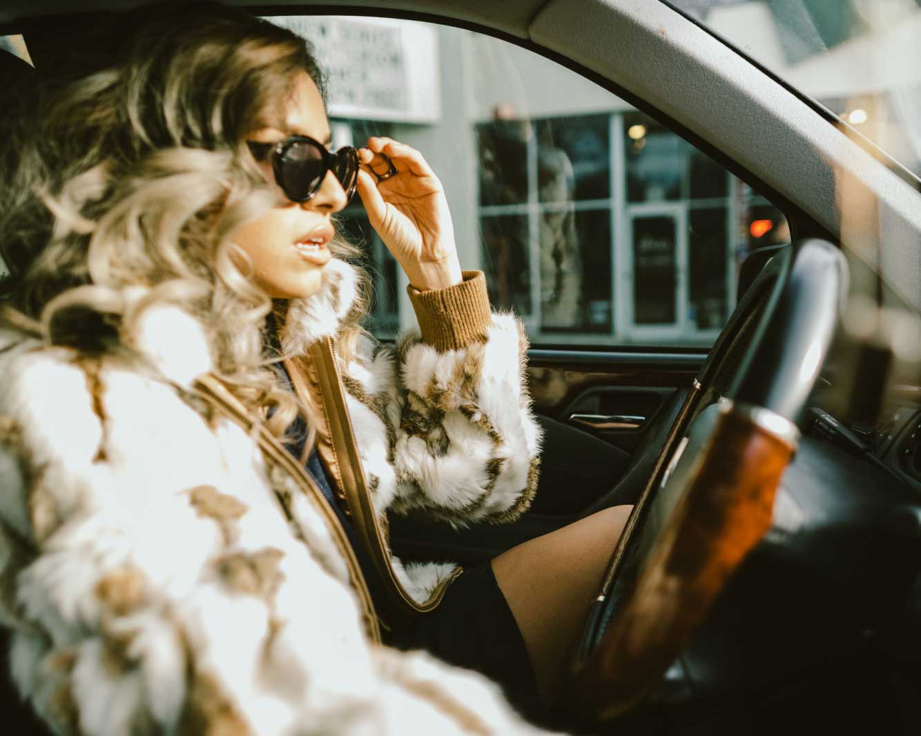 A Canadian woman, driving her car, wondering how to save on auto insurance in Ontario: