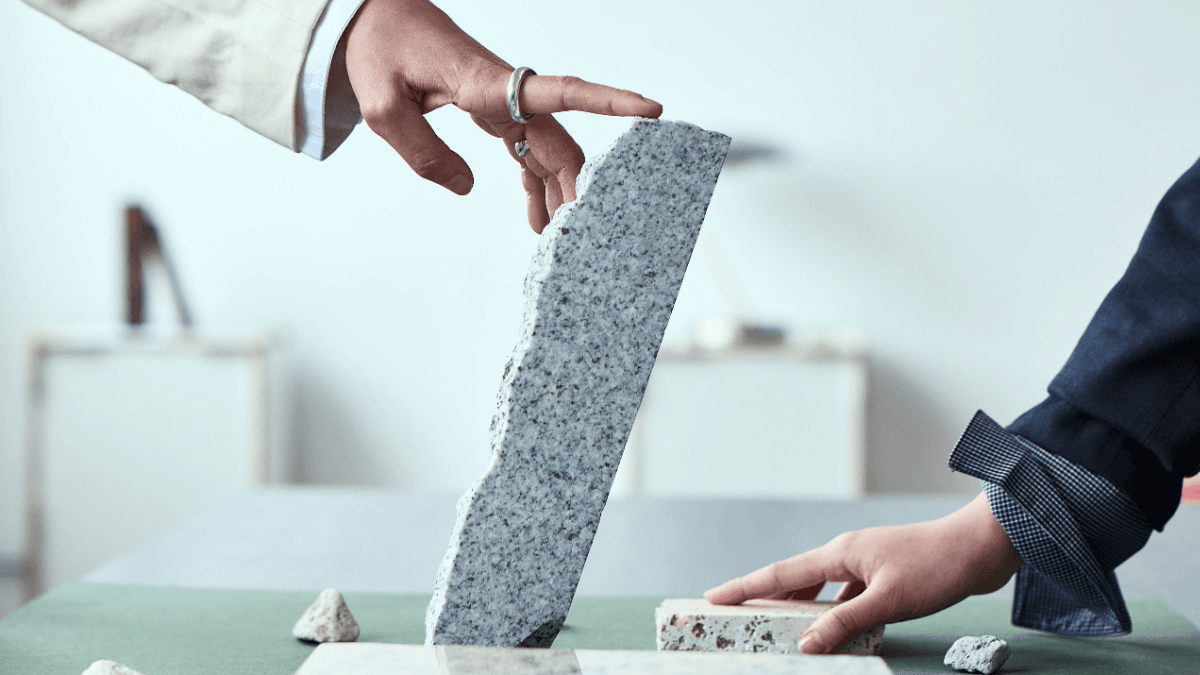 Two people's hands propping up small rocks of various sizes, symbolizing how to rebuild credit after a consumer proposal
