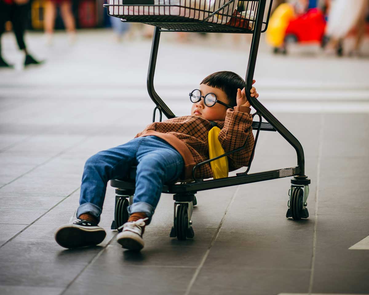 A little Canadian boy, tuckered out from trying to find back-to-school sales and deals with their parents.